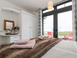 A bedroom with a bed, towels on it, and a window at Sea Haven Hunmanby Gap near Primrose Valley
