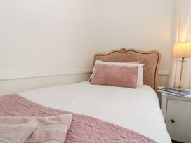 A bed with pillows and a lamp at Sea Haven in Hunmanby Gap near Primrose Valley