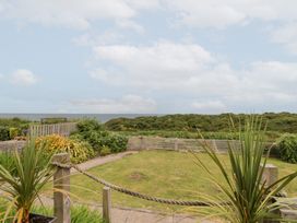 A garden with grass and plants overlooking the sea at Sea Haven near Hunmanby Gap