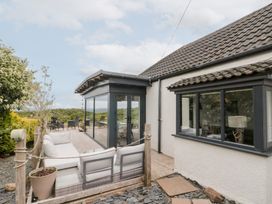 A house with a decking area and outdoor seating at Sea Haven near Hunmanby Gap