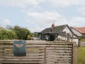 A garden with a mailbox and house in the background at Sea Haven in Hunmanby Gap near Primrose Valley