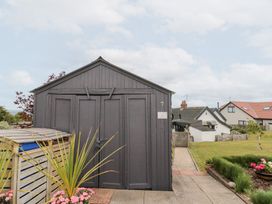 A shed with flowers and a path at Sea Haven in Hunmanby Gap near Primrose Valley