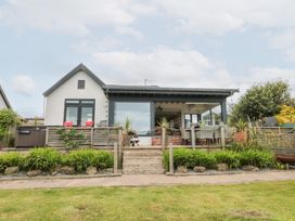 A house with steps leading to a deck at Sea Haven near Hunmanby Gap