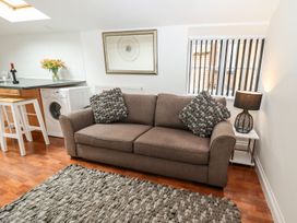 A living room with a sofa and washing machine at Bobby's in Whitby