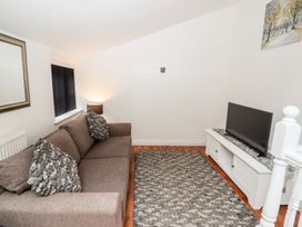 A living room with a sofa and television at Bobby's in Whitby