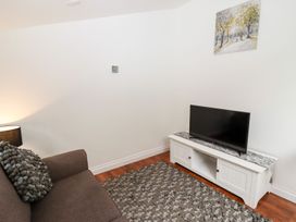 A living room with a television and a sofa at Bobby's in Whitby