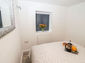 A bedroom with a bed and tray on the side table at Bobby's in Whitby