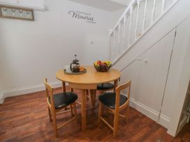 A dining room with a table and chairs at Ted's Place in Whitby