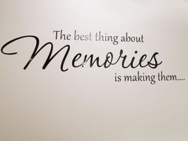 A wall with a text decoration about memories at Ted's Place in Whitby