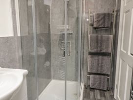 A bathroom with a shower and towels at Ted's Place in Whitby