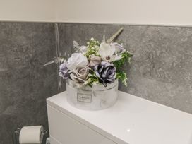 A flower arrangement on a bathroom counter at Ted's Place in Whitby