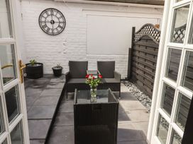 An outdoor patio with a table and chairs at Ted's Place in Whitby