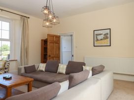 A living room with a sofa and coffee table at Littleham Court Manor Littleham near Bideford