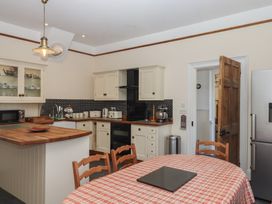 A kitchen with a table and chairs at Littleham Court Manor Littleham near Bideford
