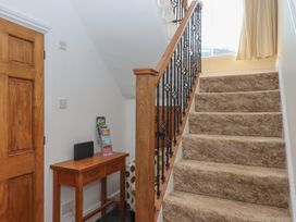 A hallway with a staircase and a console table at Littleham Court Manor Littleham near Bideford