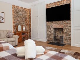 A bedroom with a sofa and television at Littleham Court Manor Littleham near Bideford