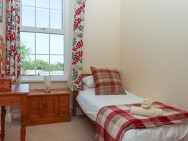 A bedroom with a single bed and a bedside table at Littleham Court Manor in Littleham near Bideford