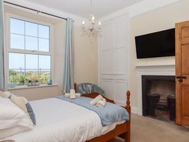 A bedroom with a window and bed at Littleham Court Manor Littleham near Bideford