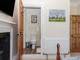 A bathroom with a toilet and radiator at Littleham Court Manor Littleham near Bideford