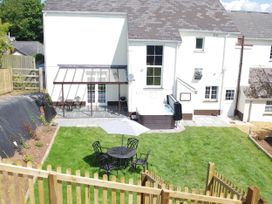 A garden with a hot tub and seating area at Littleham Court Manor Littleham near Bideford