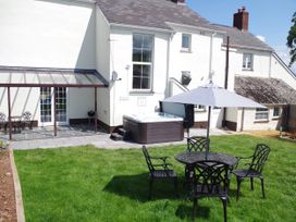 A garden with a hot tub and outdoor seating at Littleham Court Manor in Littleham near Bideford