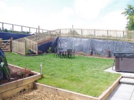 A garden with a hot tub and outdoor furniture at Littleham Court Manor in Littleham near Bideford