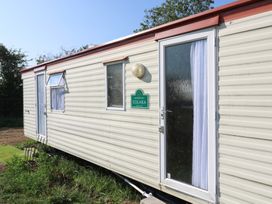 A static caravan with a door and windows at Caravan in Northampton