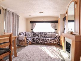 A living room with a sofa and dining table at Caravan Northampton