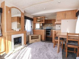 A living room with a dining table and chairs at the Caravan in Northampton