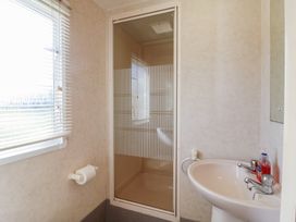 A bathroom with a shower and sink at Caravan in Northampton
