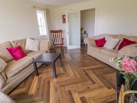 A living room with sofas and a table at Ard Na Mara 