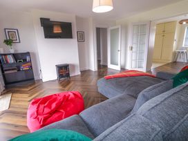 A living room with a sofa and television at Ard Na Mara