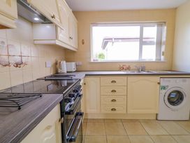 A kitchen with stove, oven, kettle and sink at Ard Na Mara in 