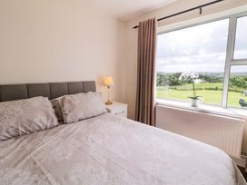 A bedroom with a bed and a view at Ard Na Mara in 