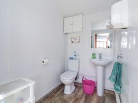 A bathroom with a toilet and sink at Shepherd's Hut in Market Weighton