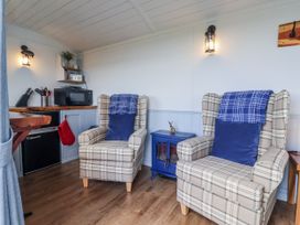 A snug with two chairs and a table at Wolds Hoot in Market Weighton