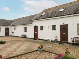 An outdoor area with buildings and benches at Florence Cottage in Holyhead