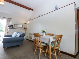 A dining area with a table and chairs in Florence Cottage Holyhead