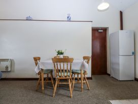 A dining room with a table and chairs at Florence Cottage in Holyhead