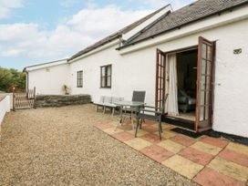 An outdoor area with a table and chairs at Florence Cottage in Holyhead