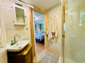 A bathroom with a sink and shower at Harvey's Lodge in Helston