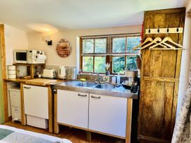 A kitchen with a sink and appliances at Harvey's Lodge in Lowertown, Helston