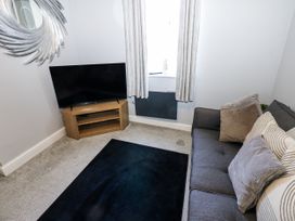 A living room with a sofa and television at Lowther House in Whitehaven