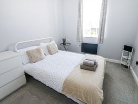 A bedroom with bed and nightstand at Lowther House in Whitehaven