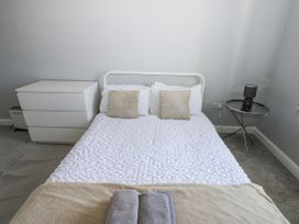 A bedroom with a bed and bedside table at Lowther House in Whitehaven