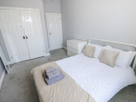 A bedroom with a bed and towels on it at Lowther House in Whitehaven