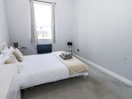 A bedroom with a bed and towels at Lowther House Whitehaven