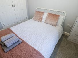 A bedroom with a bed and towels at Lowther House in Whitehaven