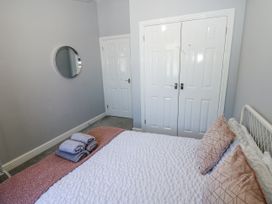 A bedroom with a bed and towels at Lowther House in Whitehaven