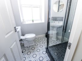 A bathroom with a shower and sink at Lowther House in Whitehaven